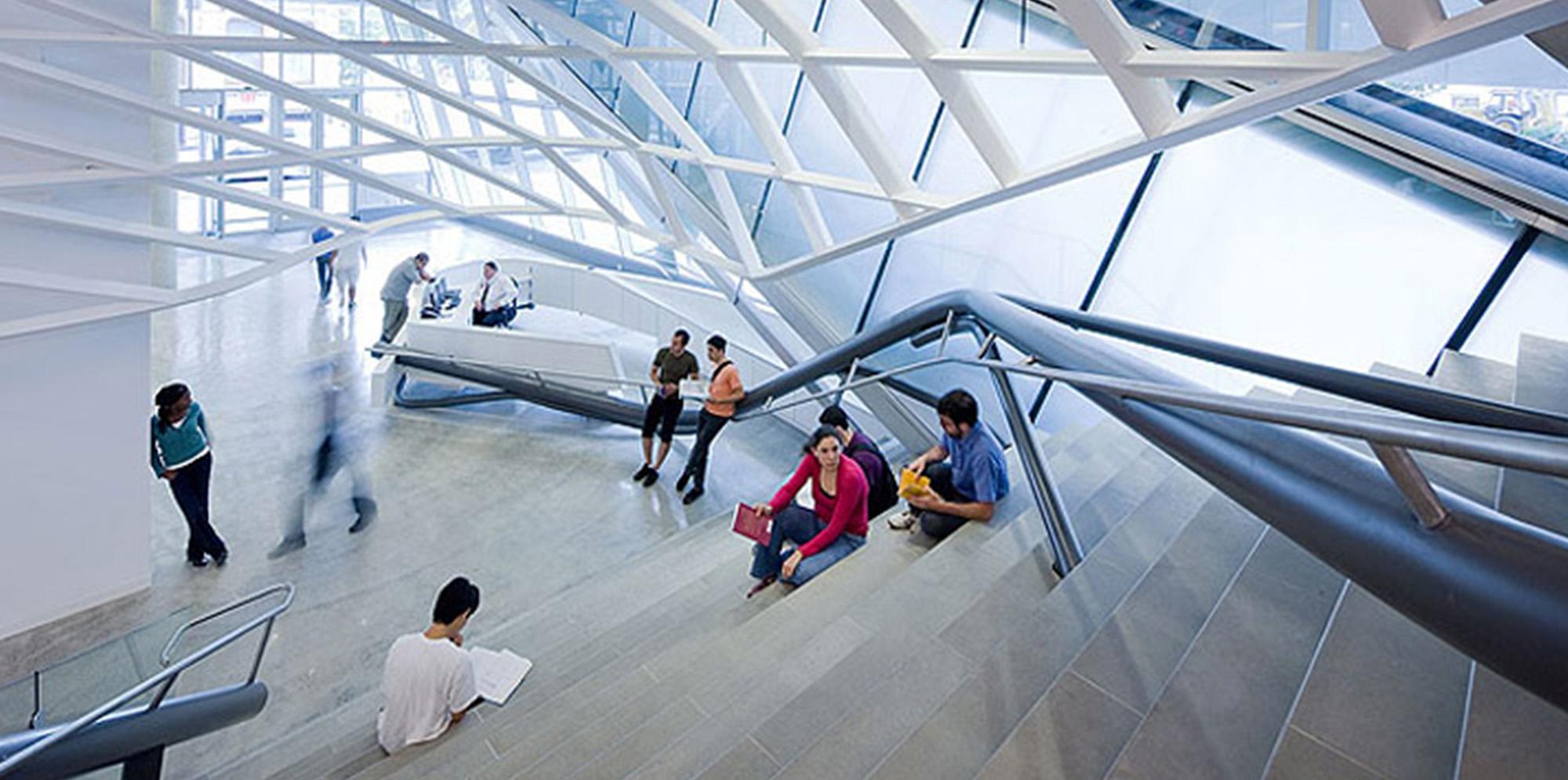 People sitting on stairs inside Cooper Union, NY